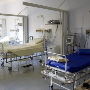 A fe w empty beds in a hospital ward.