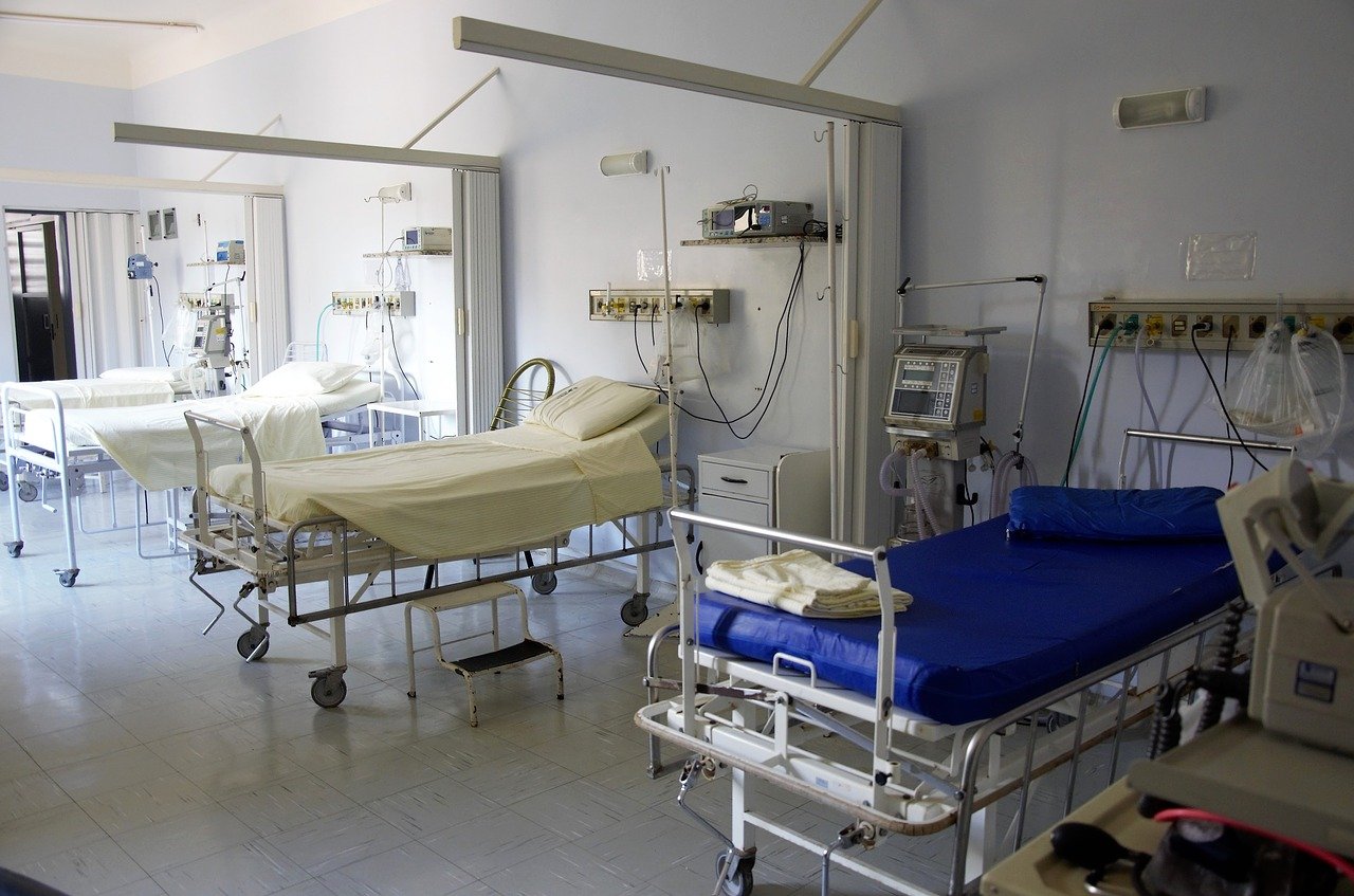 A fe w empty beds in a hospital ward.